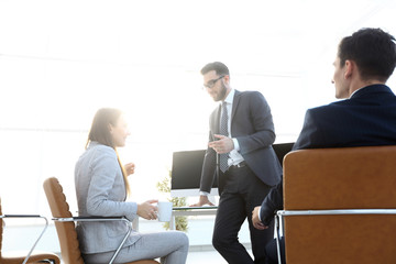 members of the business team talking in the office