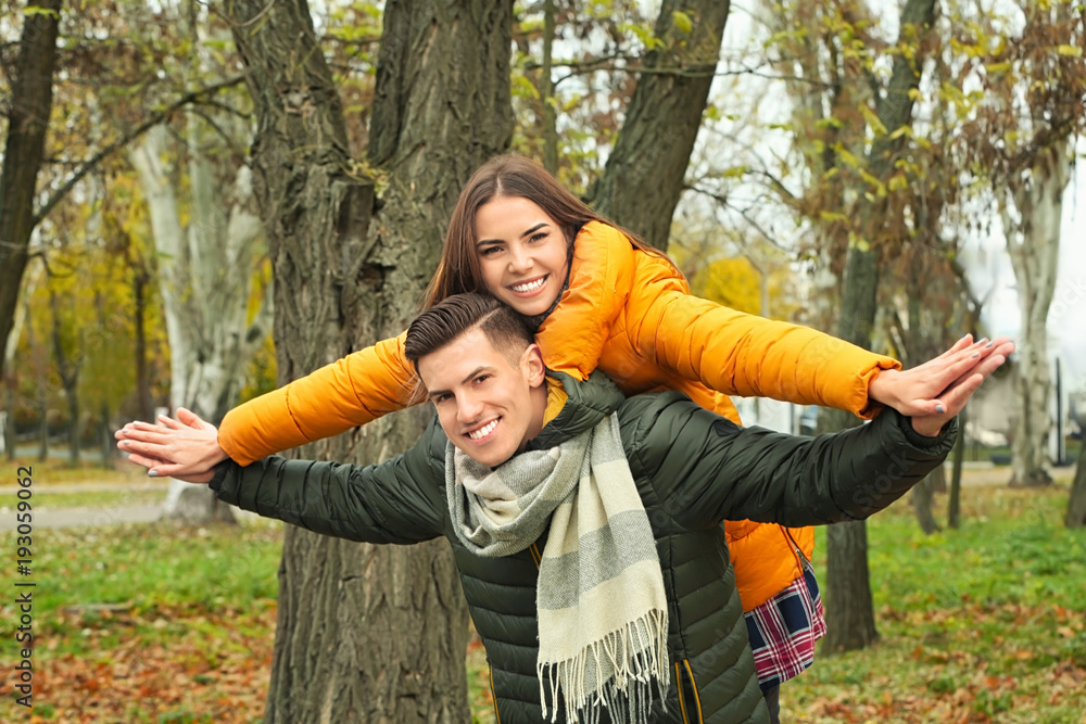 Sticker Beautiful couple in warm clothes in park