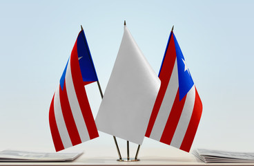 Two flags of Puerto Rico with a white flag in the middle