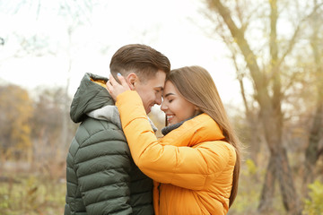 Fototapeta premium Beautiful couple in warm clothes in park