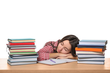 Sleeping teenager girl tired of doing homework against white background