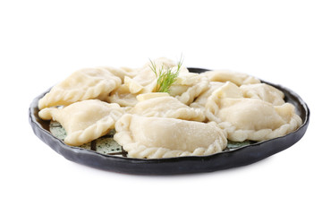 Plate with tasty dumplings on white background