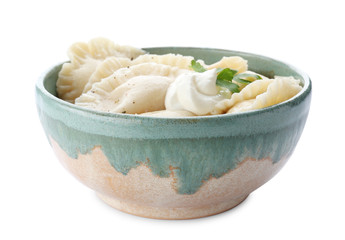 Tasty dumplings with sour cream in bowl on white background