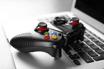 Video game controller on laptop, closeup © Africa Studio