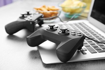 Video game controller on laptop, closeup