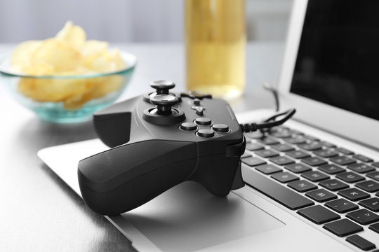 Video game controller on laptop, closeup
