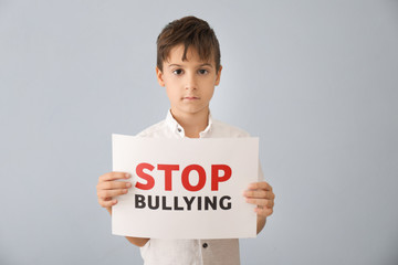 Little boy holding sign with words 