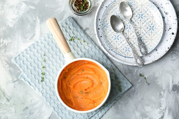 Saucepan with tasty mashed sweet potato on table