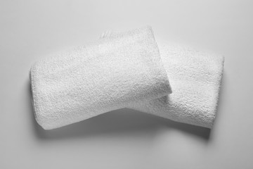 Folded clean terry towels on white background