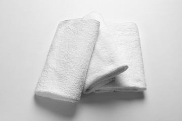 Folded clean terry towels on white background
