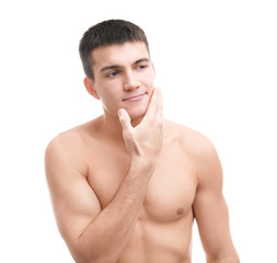 Handsome young man with soft skin after shaving against white background