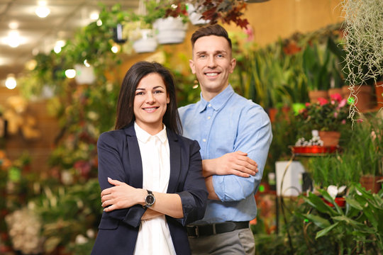 Portrait of young people in greenhouse. Small business owners