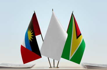 Flags of Antigua and Barbuda and Guyana with a white flag in the middle