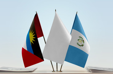 Flags of Antigua and Barbuda and Guatemala with a white flag in the middle