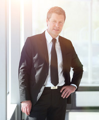 portrait of confident businessman on blurred background