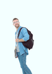 Naklejka premium A male student with a school bag holding books isolated on white background. Education opportunities. College student.