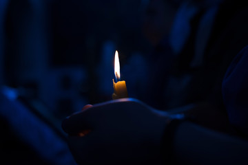 Christening in the church. Catholicism and Orthodoxy. candle on a blurred background.