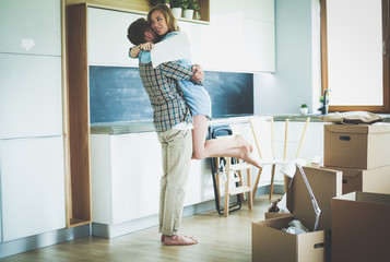 Portrait of young couple moving in new home. Young couple