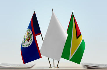 Flags of Belize and Guyana with a white flag in the middle