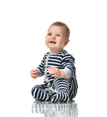 Infant child boy toddler in blue body with stripes sitting happy smiling