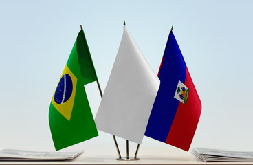 Flags of Brazil and Haiti with a white flag in the middle