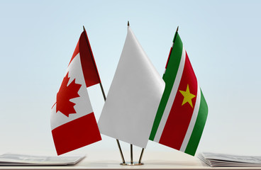 Flags of Canada and Suriname with a white flag in the middle