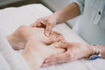Fototapeta na wymiar masseuse giving a foot massage