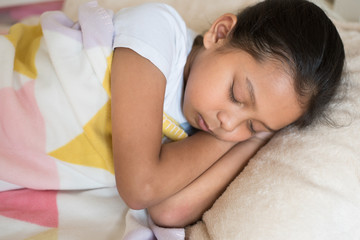 young little asian girl sleeping lying on bed in her bedroom. sleep concept