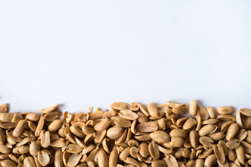 pile of fried peanut isolated on white background. background and advertising wallpaper concept