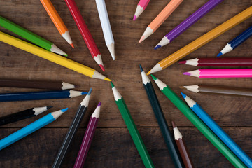 Naklejka premium multicolored pencil on a wooden table. art education and creativity concept