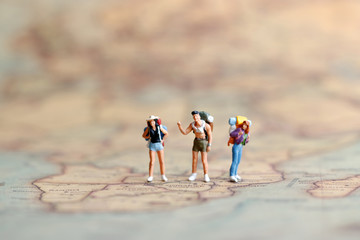 Miniature people: Backpacker on world map, Concept of Travel around the world and the adventure.