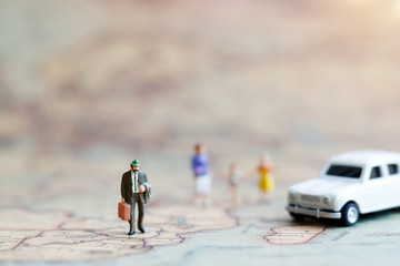 Fototapeta na wymiar Miniature people: Family walking hand in hand with on world map with car, happy family day concept.