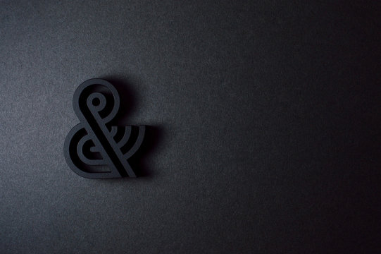 black ampersand with parallel lines on black background