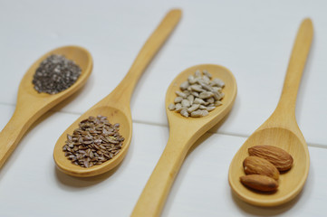 four wooden spoons with seeds