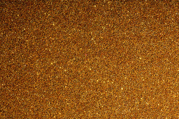 golden background with sparkles texture of large resolution yellow shiny and iridescent sequins with lights and light background
