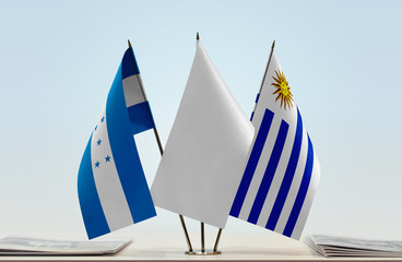 Flags of Honduras and Uruguay with a white flag in the middle