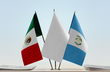 Flags of Mexico and Guatemala with a white flag in the middle