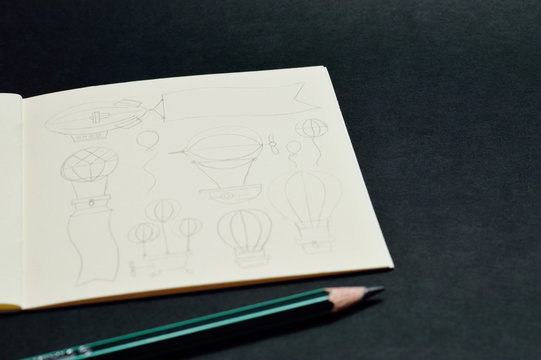 notebook with pencil sketches of balloons