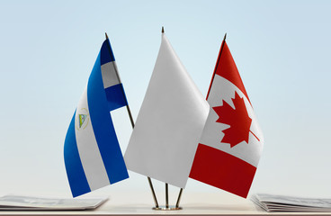 Flags of Nicaragua and Canada with a white flag in the middle