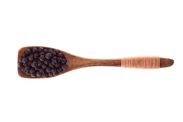 spice Black pepper grains in  wooden spoon isolated on a white background, top view