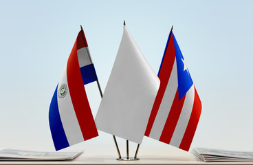 Flags of Paraguay and Puerto Rico with a white flag in the middle