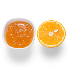 Fototapeta na wymiar Orange jam in a white bowl with orange fruit