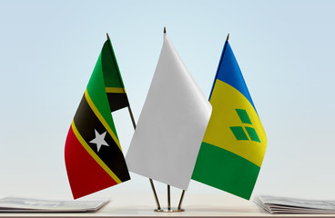 Flags of Saint Kitts and Nevis and Saint Vincent and the Grenadines with a white flag in the middle