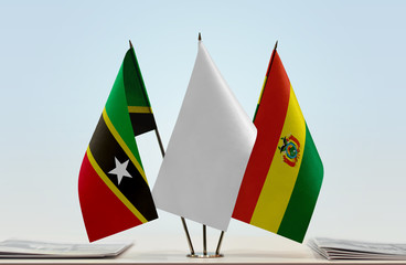 Flags of Saint Kitts and Nevis and Bolivia with a white flag in the middle