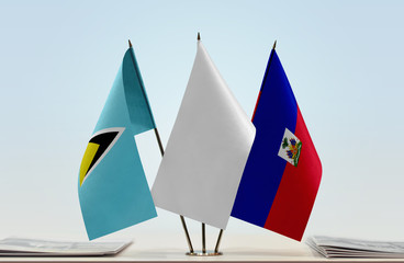Flags of Saint Lucia and Haiti with a white flag in the middle