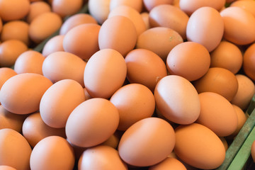 Background photo of pile fresh chicken eggs in the market.