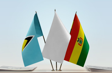 Flags of Saint Lucia and Bolivia with a white flag in the middle
