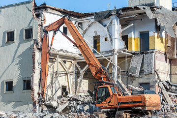 demolition of old building with excavator for new construction