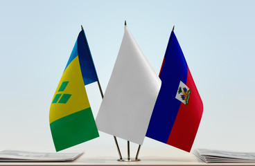 Flags of Saint Vincent and the Grenadines and Haiti with a white flag in the middle