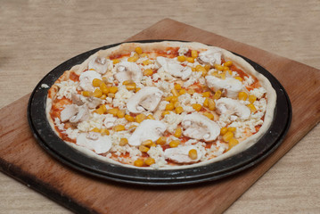 Homemade Pizza Cooking Process on Wooden Board. Process Step by Step. Pizza dough with tomatoe Pasta, Chesse, Mushrooms, and Corn and ingredients.